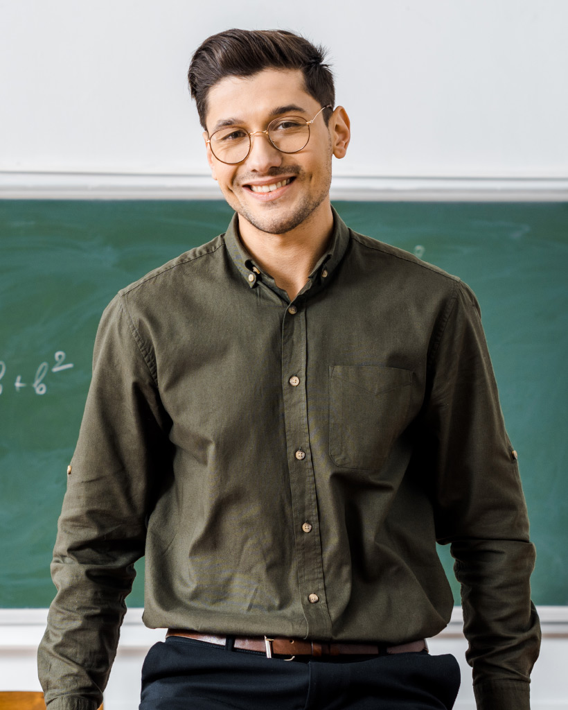 Smiling male teacher in formal wear looking at cam 2nlg2e9.jpg